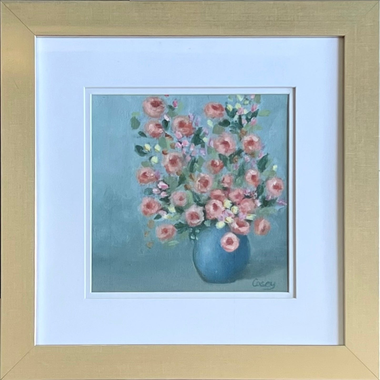 Old Garden Charm is a 12"x12" original oil painting on paper, matted and framed in soft gold. A bouquet of antique roses fills a rounded blue vase, painted in soft blush, pale yellow, and delicate green. The loose, impressionist brushwork brings a fresh sense of life to these heirloom blooms.
A romantic floral statement piece, signed by the artist and ready to hang. Perfect for bedrooms, sitting rooms, or anyone who loves vintage-inspired decor.